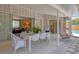 Inviting covered patio with a modern outdoor dining set and relaxing porch swing at 4151 Olive Ave, Sarasota, FL 34231