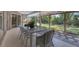 Spacious screened-in porch with a white dining set, offering a perfect spot for outdoor dining at 4151 Olive Ave, Sarasota, FL 34231