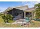 Backyard featuring a screened patio and lush landscaping at 4203 Carriage Dr # 27, Sarasota, FL 34241