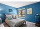 Cozy bedroom featuring wood-look floors, a window view, and beach-themed decor at 4203 Carriage Dr # 27, Sarasota, FL 34241
