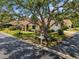 Charming single-story home featuring a well-manicured lawn and mature shade tree at 4203 Carriage Dr # 27, Sarasota, FL 34241