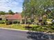 Charming single-story home featuring a well-manicured lawn and mature shade tree at 4203 Carriage Dr # 27, Sarasota, FL 34241