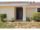 Welcoming front entrance with a well-maintained lawn and a variety of plants at 4203 Carriage Dr # 27, Sarasota, FL 34241