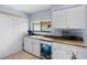 The kitchen features a charming turtle-themed design on the dishwasher and white cabinets at 4203 Carriage Dr # 27, Sarasota, FL 34241