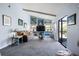 Comfortable living room with a plush sofa, large windows, and a sliding glass door to the outside at 4203 Carriage Dr # 27, Sarasota, FL 34241