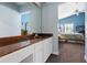 Bathroom featuring a vanity with white cabinets and a view into the bedroom at 4203 Carriage Dr # 27, Sarasota, FL 34241