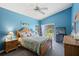 Serene bedroom with blue walls, wood furniture, and sliding glass doors to the patio at 4203 Carriage Dr # 27, Sarasota, FL 34241