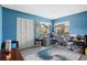 This office features natural light from its large windows, a stylish rug, and white closet doors at 4203 Carriage Dr # 27, Sarasota, FL 34241
