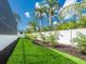 Lush green backyard with well-maintained lawn and tropical landscaping at 430 Pheasant Way, Sarasota, FL 34236