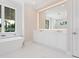 Luxurious bathroom featuring a modern soaking tub, double vanity, and ample natural light at 430 Pheasant Way, Sarasota, FL 34236