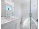 Bright bathroom with a glass enclosed shower, a vanity with white cabinets, and updated fixtures at 430 Pheasant Way, Sarasota, FL 34236