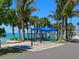 Picturesque beach area with palm trees, a covered seating area, and a walking path near the water at 430 Pheasant Way, Sarasota, FL 34236