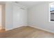 Bright bedroom featuring hardwood floors, a window, and a closet with sliding doors at 430 Pheasant Way, Sarasota, FL 34236