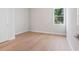Empty bedroom with light wood flooring and natural light from a window at 430 Pheasant Way, Sarasota, FL 34236