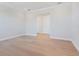 This bedroom features light wood floors, crown molding, and a hallway leading to a closet at 430 Pheasant Way, Sarasota, FL 34236