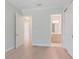 Spacious bedroom with light wood floors, featuring an ensuite bathroom and walk in closet at 430 Pheasant Way, Sarasota, FL 34236