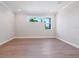 Bright bedroom with hardwood floors and large windows showcasing lush tropical views at 430 Pheasant Way, Sarasota, FL 34236