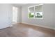Bedroom with hardwood floors, crown moulding, and a large window with beautiful exterior views at 430 Pheasant Way, Sarasota, FL 34236