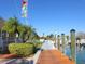 Beautiful waterfront community dock featuring wood planking, boat slips, and tropical landscaping at 430 Pheasant Way, Sarasota, FL 34236