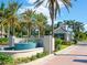 Bird Key entrance featuring a fountain and guard house, lined with palm trees at 430 Pheasant Way, Sarasota, FL 34236