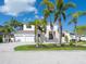 Beautiful two-story home boasting mature palms, lush landscaping, and a paver driveway leading to a two-car garage at 430 Pheasant Way, Sarasota, FL 34236