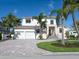 Elegant two-story home featuring a lush, landscaped yard and a spacious three-car garage at 430 Pheasant Way, Sarasota, FL 34236