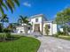 Beautiful home with well-manicured lawn, mature landscaping, and three-car garage at 430 Pheasant Way, Sarasota, FL 34236