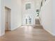 Bright foyer featuring a grand staircase, soaring ceilings, and decorative glass french doors at 430 Pheasant Way, Sarasota, FL 34236