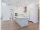 Bright kitchen area featuring stainless steel appliances, a center island, and white cabinetry in an open-concept design at 430 Pheasant Way, Sarasota, FL 34236