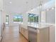 Spacious kitchen with an island sink, stainless steel dishwasher, and views of the backyard at 430 Pheasant Way, Sarasota, FL 34236
