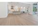 Expansive open concept kitchen, complete with a central island, sleek white cabinetry, and stainless steel appliances at 430 Pheasant Way, Sarasota, FL 34236