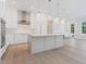 Modern kitchen with white cabinetry, stainless steel appliances, a stylish central island, and pendant lighting at 430 Pheasant Way, Sarasota, FL 34236