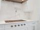 Focus on the stylish range, complete with a pot filler faucet, set against a backdrop of white cabinetry and backsplash at 430 Pheasant Way, Sarasota, FL 34236