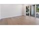Bright living room features wood flooring, sliding glass doors, and a view of the outdoor grill at 430 Pheasant Way, Sarasota, FL 34236