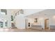 Spacious living room with a staircase leading to the second floor, a kitchen, and adjacent bar at 430 Pheasant Way, Sarasota, FL 34236