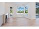 Bright living room with an adjacent bar featuring a wine cooler, access to the lanai, and a corner window at 430 Pheasant Way, Sarasota, FL 34236