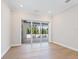 Living room with wood floors and sliding glass doors at 430 Pheasant Way, Sarasota, FL 34236