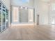 Bright living room with access to the lanai and a stone accent wall with custom lighting at 430 Pheasant Way, Sarasota, FL 34236
