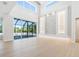 Large living room with access to the lanai featuring a swimming pool, stone accent wall, and recessed lighting at 430 Pheasant Way, Sarasota, FL 34236