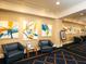 Comfortable lounge area featuring modern artwork, comfortable seating, and patterned carpeting at 430 Pheasant Way, Sarasota, FL 34236