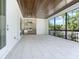 Spacious screened lanai featuring an outdoor kitchen with stainless steel appliances and granite countertops at 430 Pheasant Way, Sarasota, FL 34236
