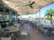 Covered patio dining area featuring neutral seating and beautiful waterfront views at 430 Pheasant Way, Sarasota, FL 34236