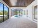 Covered patio overlooking a screened-in pool and lush tropical landscaping at 430 Pheasant Way, Sarasota, FL 34236