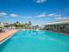 Resort style pool with ample seating, a covered pavilion, and beautiful tropical landscaping at 430 Pheasant Way, Sarasota, FL 34236