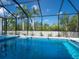 Gorgeous screen-enclosed pool area with lush landscaping and a serene atmosphere at 430 Pheasant Way, Sarasota, FL 34236