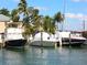 Beautiful waterfront property featuring boat slips and a variety of vessels at 430 Pheasant Way, Sarasota, FL 34236
