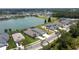 Aerial shot showcasing a home with a screened-in pool and a tranquil lake in a residential neighborhood at 4406 Rustling Pines Ter, Parrish, FL 34219
