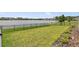 Spacious backyard with a black fence and beautiful views of the lake at 4406 Rustling Pines Ter, Parrish, FL 34219