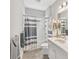 Clean bathroom features a shower with gray striped curtain, a white vanity, and tile flooring at 4406 Rustling Pines Ter, Parrish, FL 34219