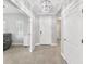 Bright foyer with tiled floor, chandelier, and white front door at 4406 Rustling Pines Ter, Parrish, FL 34219